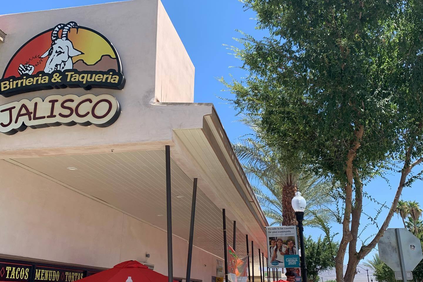 Their building on Sixth Street: the round goat sign, the yellow JALISCO plate, the patio under the awning